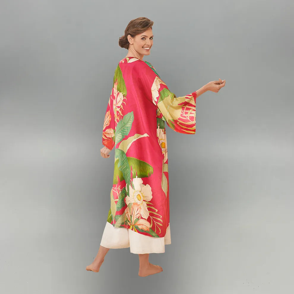 Woman wearing a colorful floral kimono against a gray background