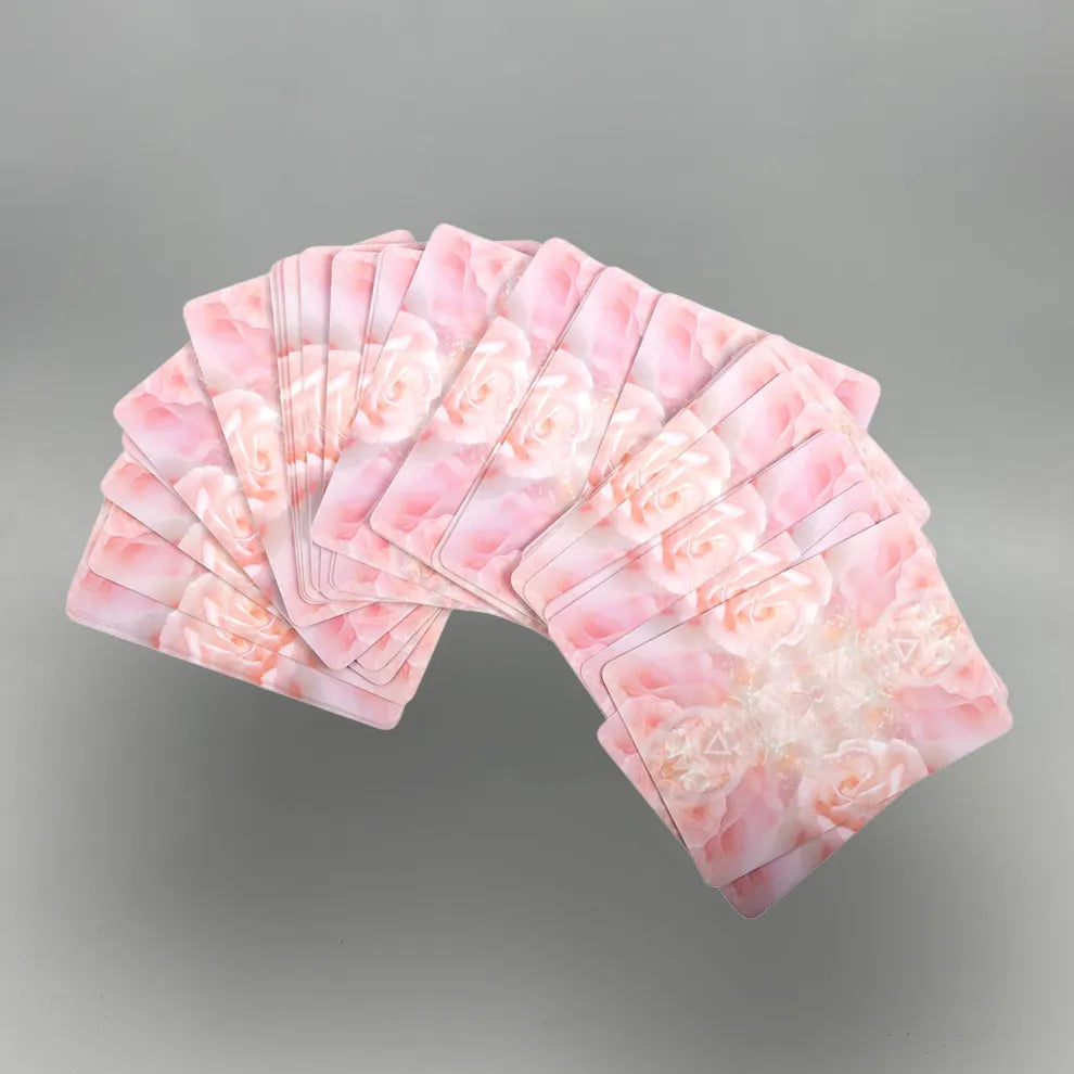 Set of pink playing cards fanned out on a gray background
