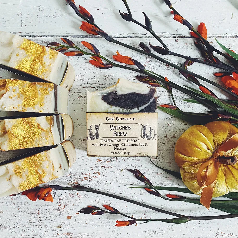 Handcrafted Witches Brew luxury soap with decorative elements on a rustic surface.