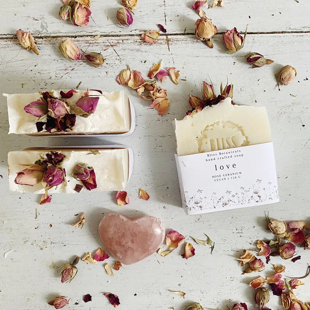Love Handmade Soap on a wooden surface with petals