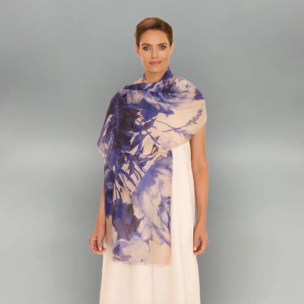 Woman wearing a china blue blooms scarf on a gray background