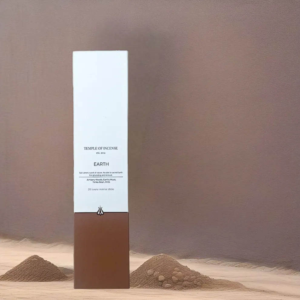 Temple of Incense Earth product packaging with sand and stones in the background