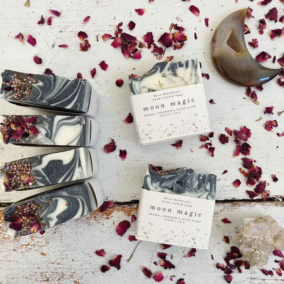 Marble-patterned luxury moon magic soap bars on a rustic surface with dried flowers.