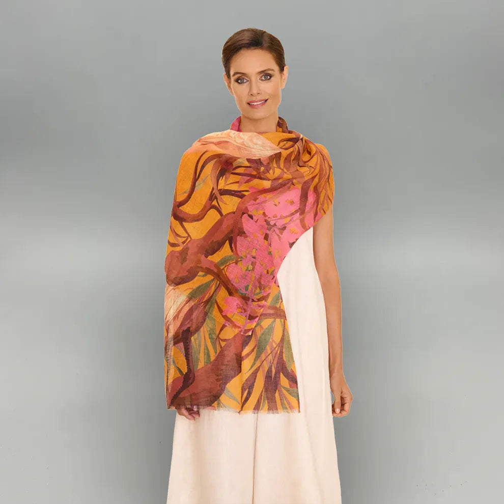 Woman wearing a colorful oriental crane scarf on a gray background