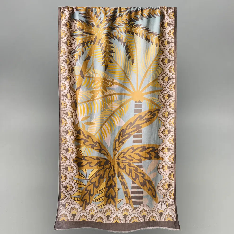 Scarf with patterned palm leaf design on a gray background