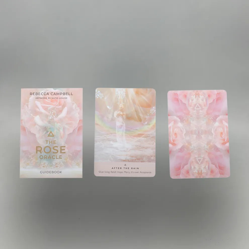 Three cards from 'The Rose Oracle' guidebook on a gray background