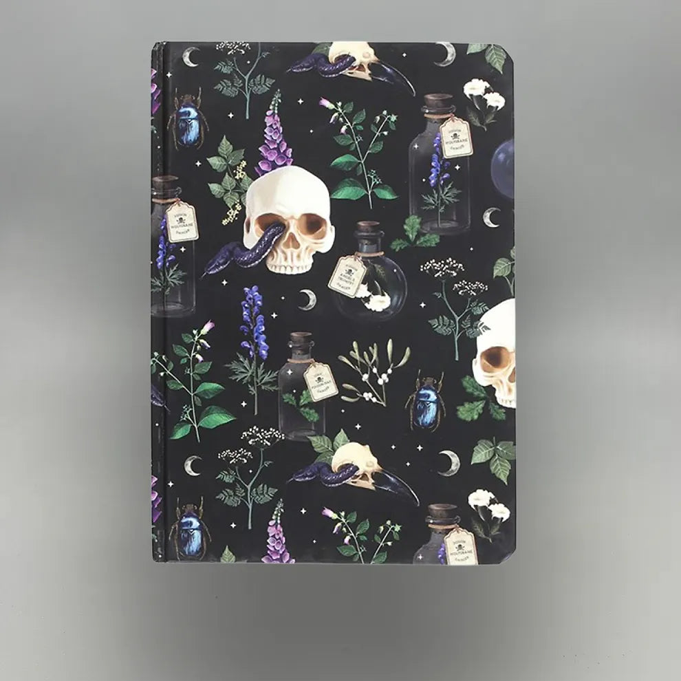 Notebook with skull and potion design on a dark background