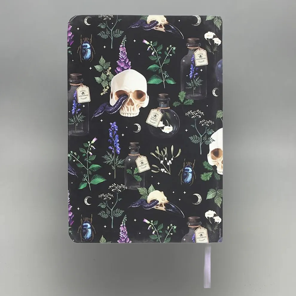 Notebook with skull and potion design on a dark background