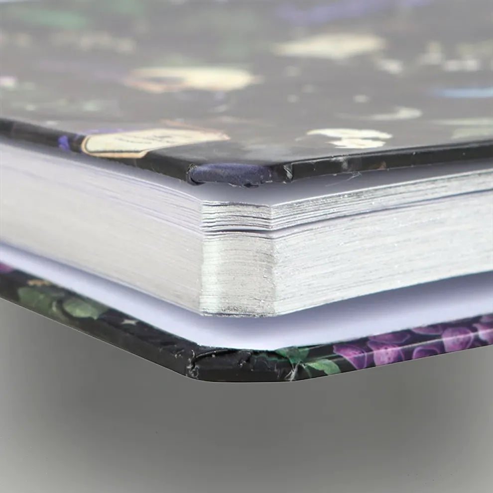 Close-up of a venom and vines notebooks decorative edge on a gray background