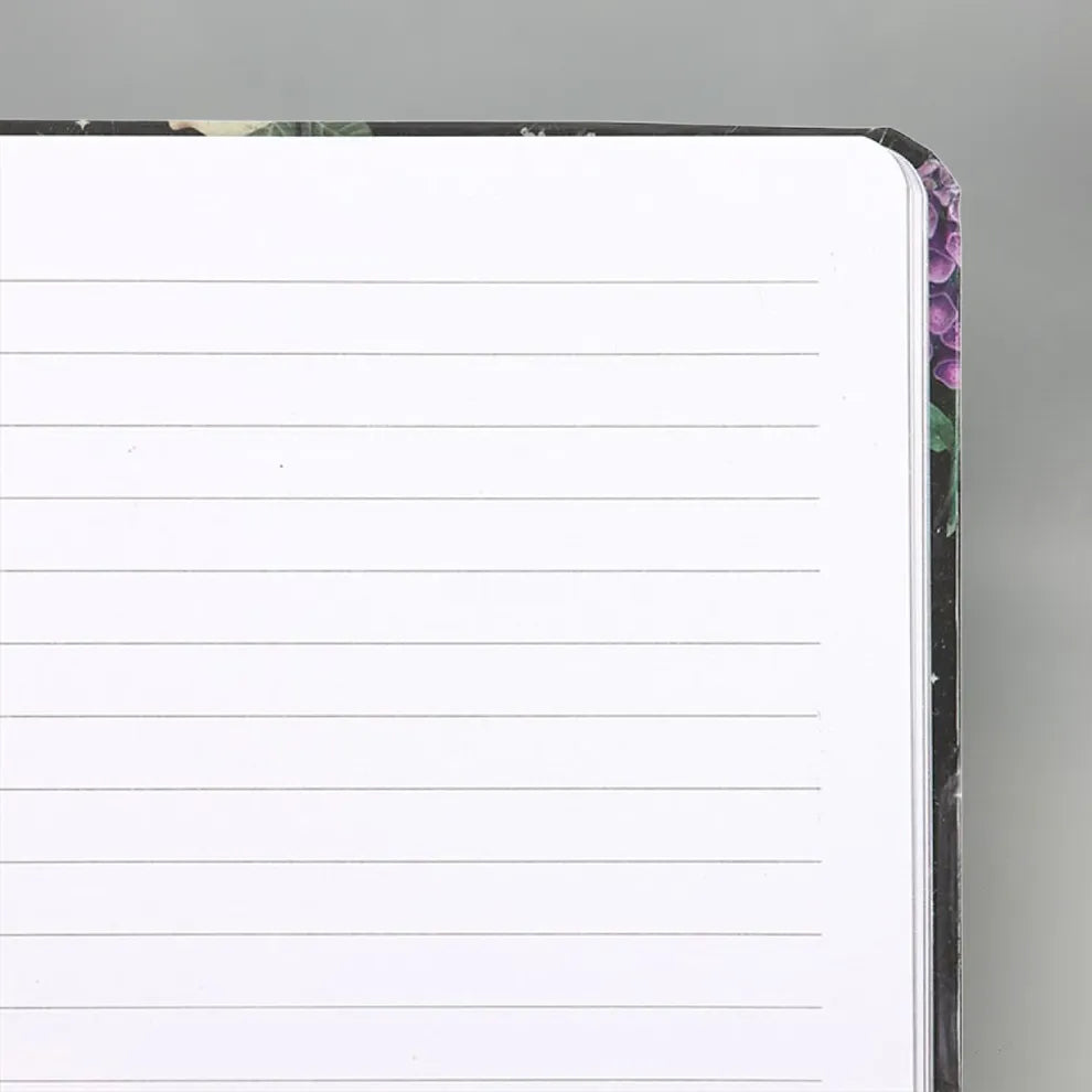 Venom and vines notebook with lined pages on a gray background
