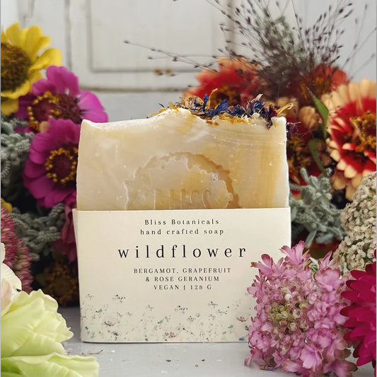 Handcrafted luxury wildflower soap bar surrounded by flowers