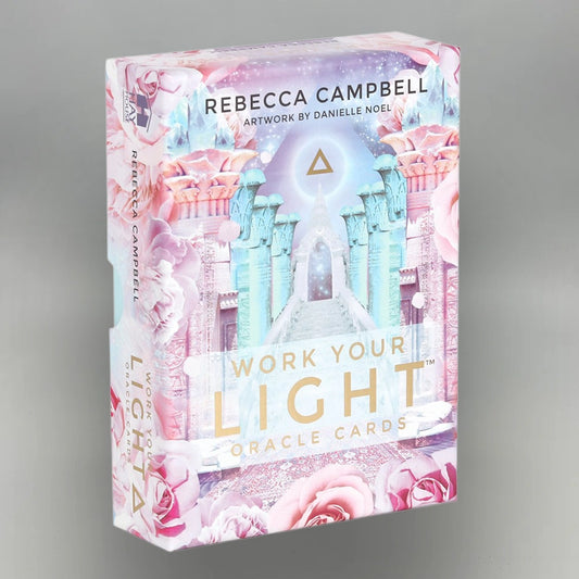 Box of 'Work Your Light' Oracle Cards by Rebecca Campbell on a gray background